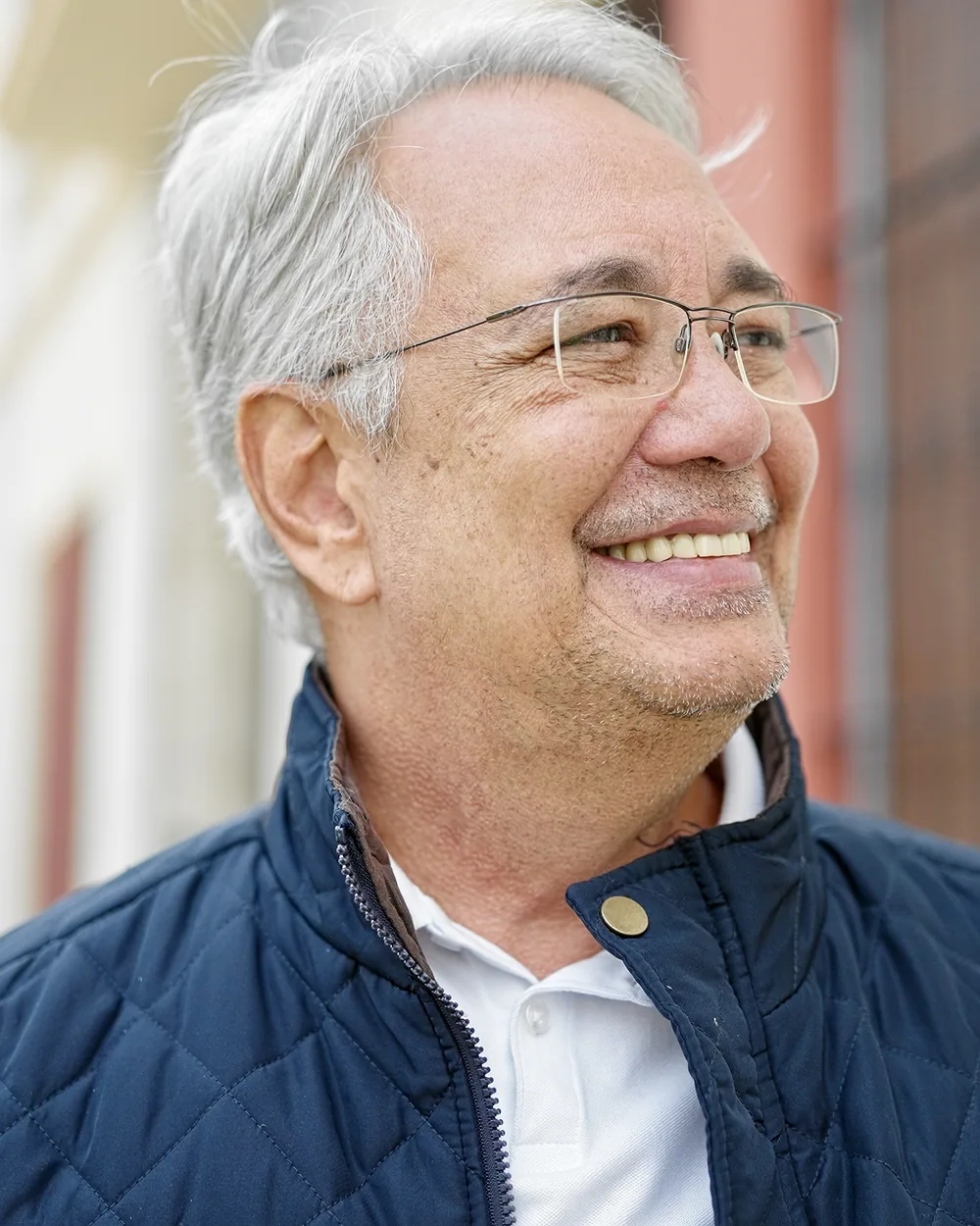 Smiling older man standing outdoors