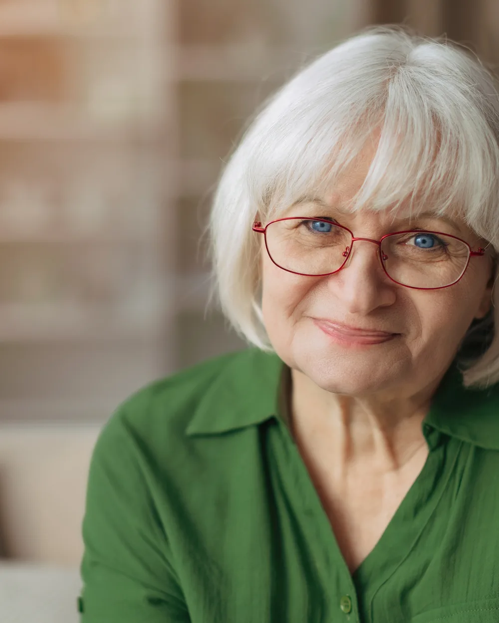 Smiling older woman in a green top