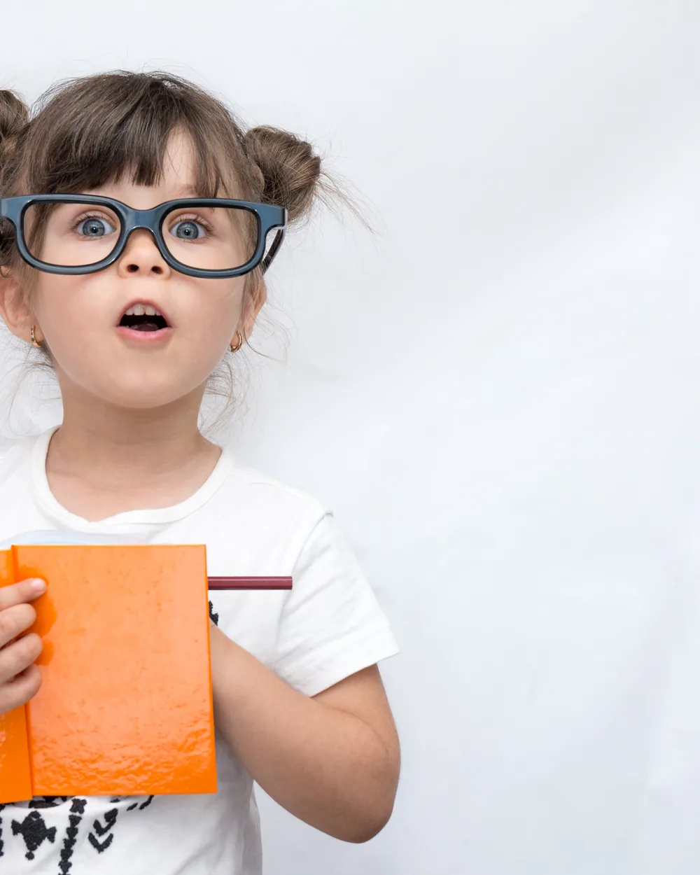 Young child holding an orange book