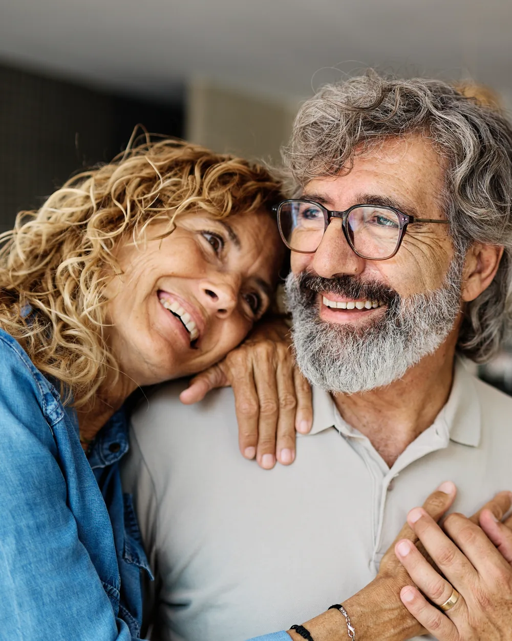 Smiling older couple relaxing together at home