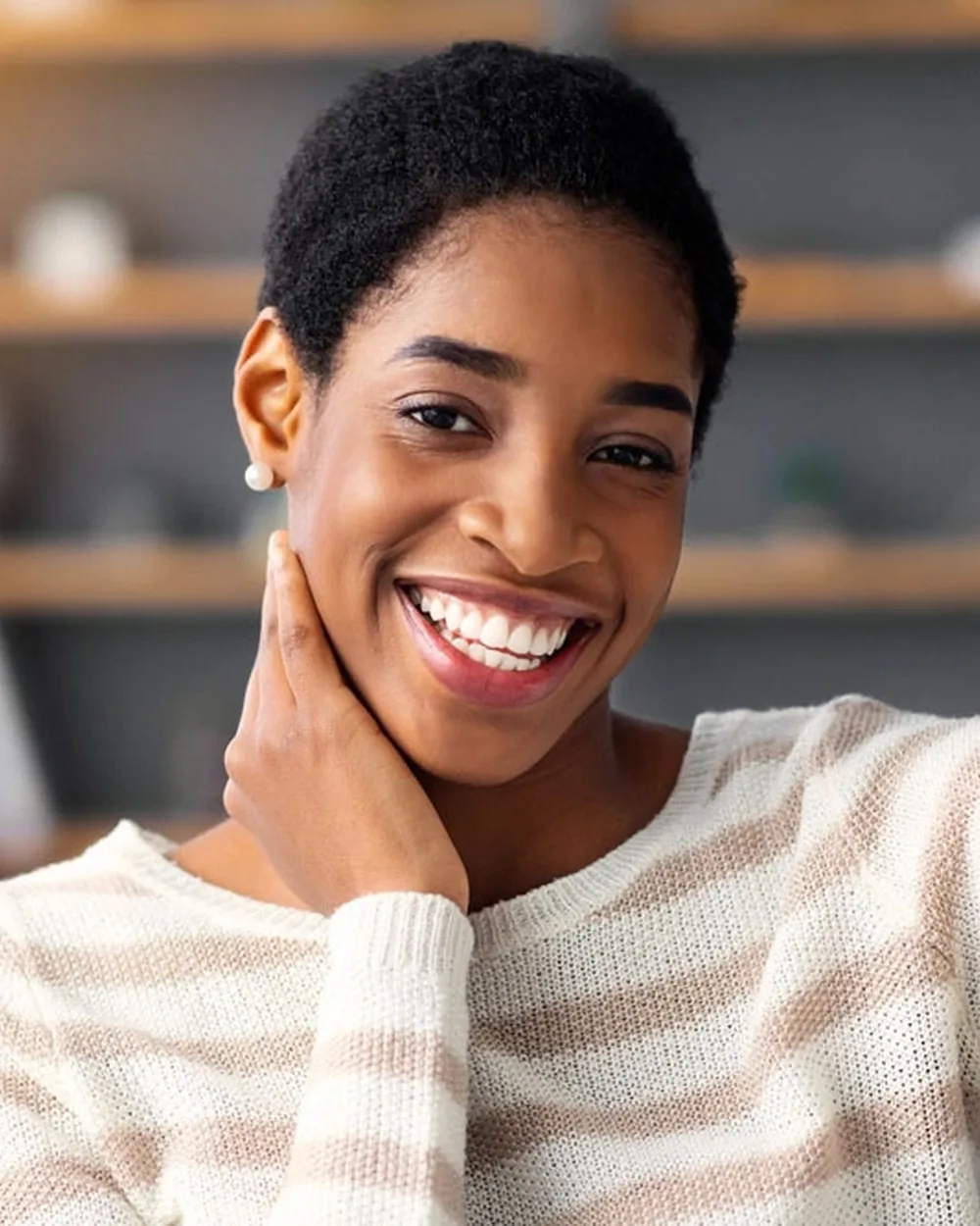 Woman gently resting her hand near her jaw