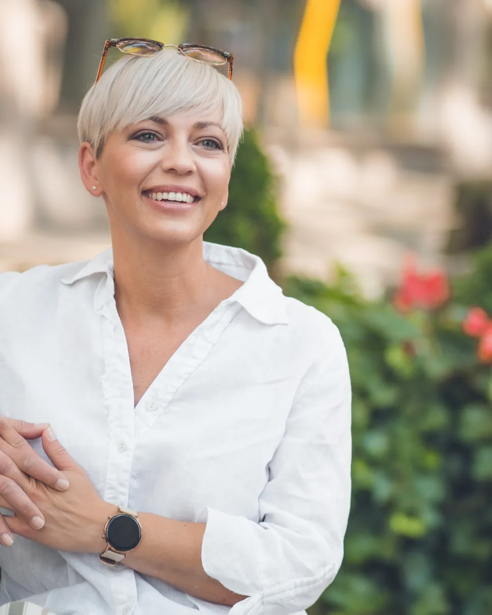 Smiling woman in a white blouse outdoors