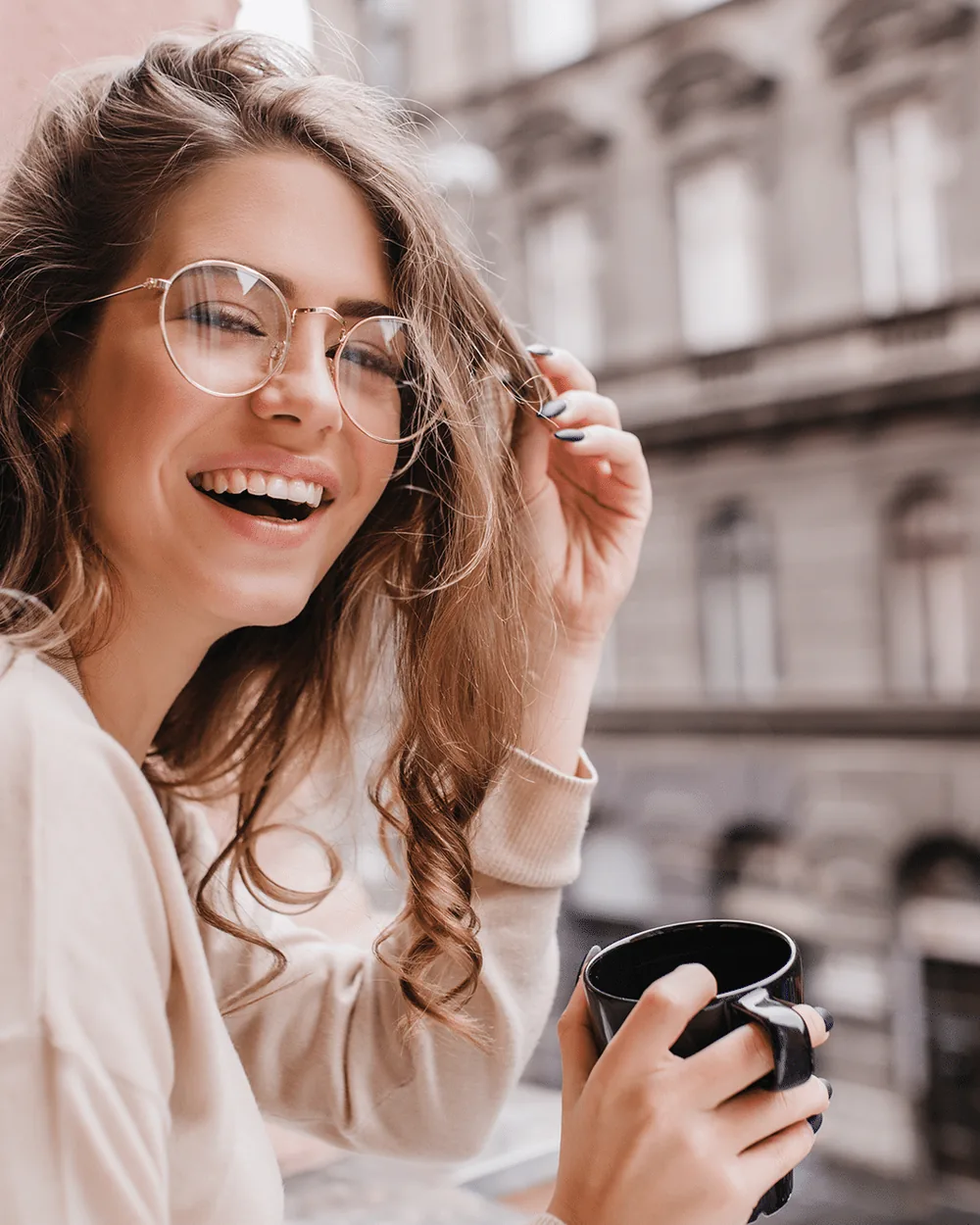 Smiling woman with glasses in the city