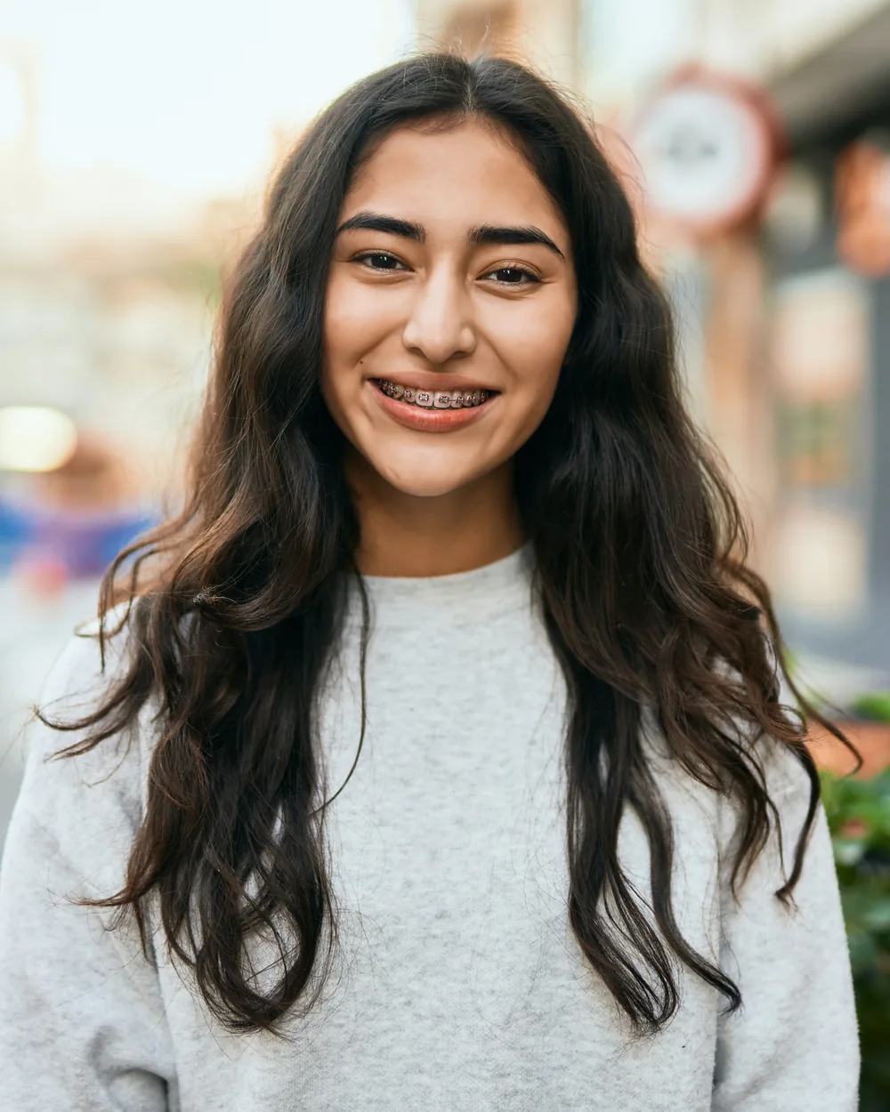 Smiling young woman standing outdoors